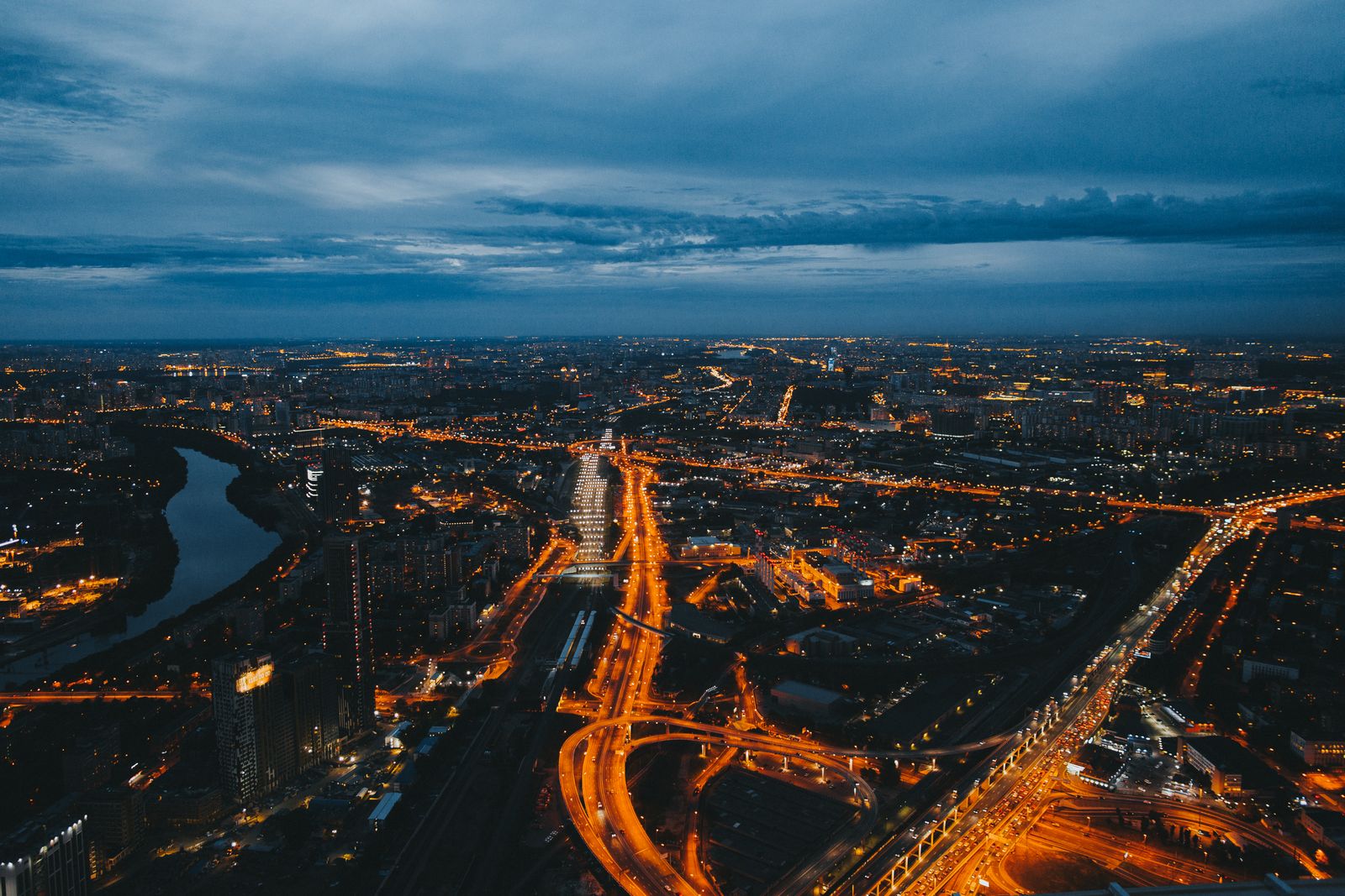 City lights and roads seen from above after dark