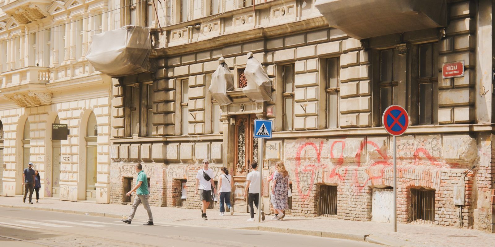 A pedestrian street lined with older buildings