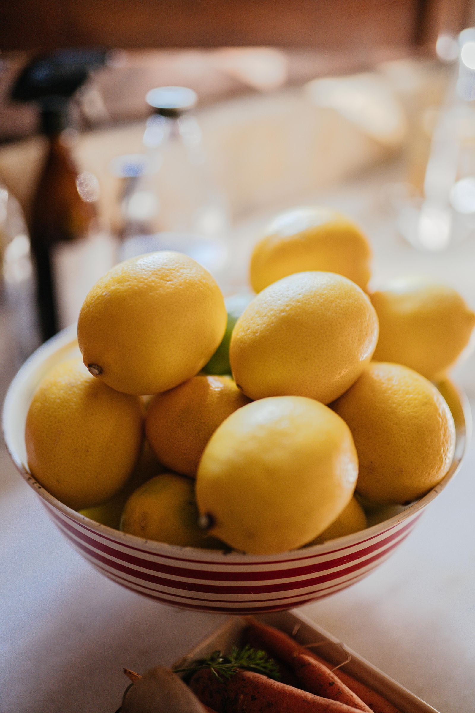 Several fresh lemons in a shallow kitchen bowl