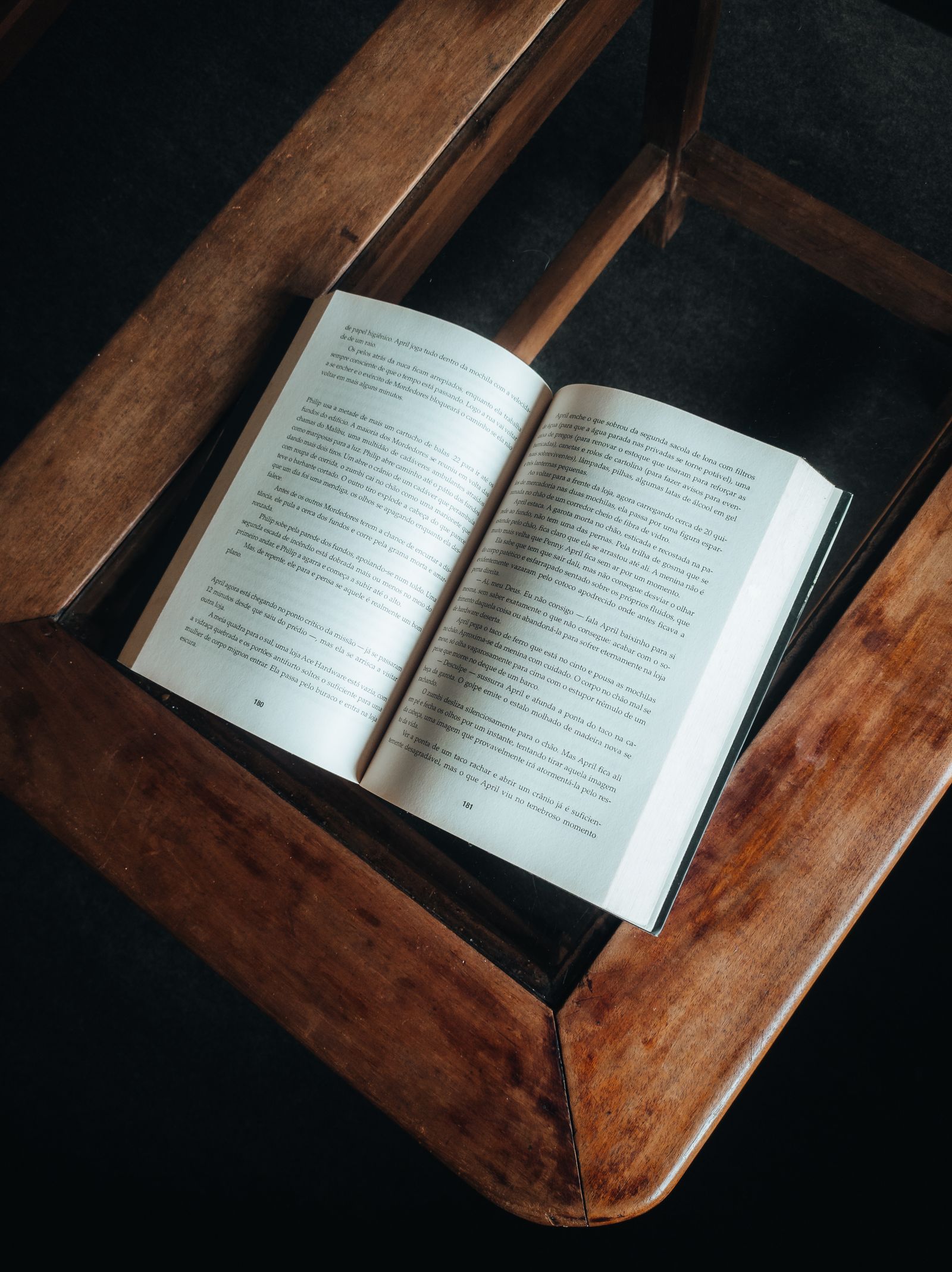 An open book resting beside a ceramic cup